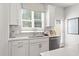 Bright kitchen with a stainless steel sink, white cabinets, and stylish backsplash at 206 Maycrest Path, Tucker, GA 30084