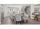 Eat-in kitchen with stainless steel appliances, white cabinets, center island, staircase, and wood-style flooring at 206 Maycrest Path, Tucker, GA 30084