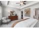 Spacious main bedroom featuring tray ceilings, chair, dresser, and ensuite bath at 206 Maycrest Path, Tucker, GA 30084