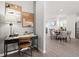 Interior view of a home office nook featuring a modern desk, chair, and stylish decor with dining area adjacent at 206 Maycrest Path, Tucker, GA 30084