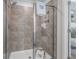 Detail of modern shower with large shower head, built-in shelving, and glass door at 206 Maycrest Path, Tucker, GA 30084