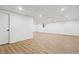 Finished basement features wood-look flooring, white walls, paneled doors, and recessed lighting at 383 Oakridge Dr, Cartersville, GA 30121