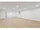 Spacious basement with wood-look flooring, recessed lighting, white walls, and paneled doors at 383 Oakridge Dr, Cartersville, GA 30121