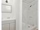 Bathroom with gray vanity, large mirror, and tiled shower at 383 Oakridge Dr, Cartersville, GA 30121