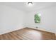 Bedroom featuring wood-look flooring, white walls, and a window with outdoor views at 383 Oakridge Dr, Cartersville, GA 30121
