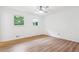 Bright bedroom features wood-look flooring, white walls, ceiling fan, and natural light from two windows at 383 Oakridge Dr, Cartersville, GA 30121