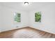 Bright bedroom features wood-look flooring, white walls, and natural light from two windows at 383 Oakridge Dr, Cartersville, GA 30121