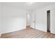 Bedroom with wood-look flooring, white walls, closet, and access to another room at 383 Oakridge Dr, Cartersville, GA 30121