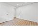 Bedroom with wood-look floors, white walls, and paneled doors leading to a closet and hall at 383 Oakridge Dr, Cartersville, GA 30121