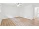 Bedroom featuring wood-look flooring, white walls, ceiling fan, and a doorway to the hall at 383 Oakridge Dr, Cartersville, GA 30121