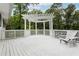White wooden deck with a white pergola and seating area at 383 Oakridge Dr, Cartersville, GA 30121