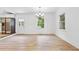 Open dining room with hardwood floors, bright lighting, large window, and stainless steel appliances in kitchen at 383 Oakridge Dr, Cartersville, GA 30121