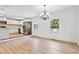 Open dining room with hardwood floors, bright lighting, large window, and stainless steel appliances in kitchen at 383 Oakridge Dr, Cartersville, GA 30121