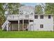 Back exterior view of the home showcasing a pergola covered deck and staircase at 383 Oakridge Dr, Cartersville, GA 30121