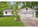 Charming home featuring a two-car garage, vinyl siding, and green lawn at 383 Oakridge Dr, Cartersville, GA 30121