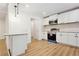 Bright open kitchen featuring white cabinets, stainless steel appliances, modern backsplash, and hardwood floors at 383 Oakridge Dr, Cartersville, GA 30121