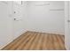 Mud room with wood-look flooring, white walls, coat hooks, and a white door at 383 Oakridge Dr, Cartersville, GA 30121