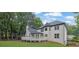 Exterior view of the home, displaying the spacious back deck and well-maintained lawn with privacy at 525 Old Path Xing, Roswell, GA 30075