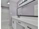 Bathroom vanity featuring large mirror, modern fixtures, and stylish white cabinetry at 525 Old Path Xing, Roswell, GA 30075