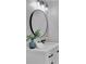 Modern bathroom featuring a sleek round mirror, stylish vanity, and updated lighting at 525 Old Path Xing, Roswell, GA 30075