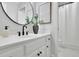 Bathroom with white vanity, round mirror, and white tiled floors at 525 Old Path Xing, Roswell, GA 30075
