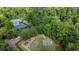 Aerial view of tennis courts, a playground, and a basketball court in a private, wooded community at 525 Old Path Xing, Roswell, GA 30075