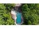 Aerial view of the community pool and recreational area surrounded by lush greenery and trees at 525 Old Path Xing, Roswell, GA 30075