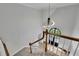 Bright foyer featuring a modern light fixture, stairs, and views of the front door and exterior at 525 Old Path Xing, Roswell, GA 30075