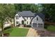 Charming two-story home featuring a well-manicured lawn and a welcoming two-car garage at 525 Old Path Xing, Roswell, GA 30075