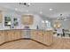 Bright kitchen featuring light wood cabinets, stainless steel appliances, hardwood floors, and open to dining area at 525 Old Path Xing, Roswell, GA 30075