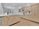 Bright kitchen features light wood cabinets, stainless steel appliances, hardwood floors, and white countertops at 525 Old Path Xing, Roswell, GA 30075