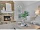 Living room showing the fireplace, large windows with shutters, and comfortable seating at 525 Old Path Xing, Roswell, GA 30075