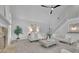 Living room with high ceilings, fireplace, neutral paint, plush carpet, staircase, and large windows at 525 Old Path Xing, Roswell, GA 30075
