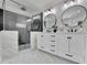 A luxurious bathroom features a glass shower, double vanity, modern lighting, and neutral color scheme at 525 Old Path Xing, Roswell, GA 30075