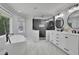 A luxurious main bathroom features a standalone tub, glass shower, and a double vanity with marble floors at 525 Old Path Xing, Roswell, GA 30075