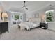 Spacious main bedroom featuring tray ceiling, bay window, and neutral color scheme with carpet at 525 Old Path Xing, Roswell, GA 30075