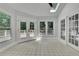 Sunroom with skylight, tile floors, windows with backyard views, and access to deck at 525 Old Path Xing, Roswell, GA 30075