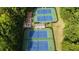 Overhead view of tennis courts with manicured landscaping, and a small court side shaded area at 525 Old Path Xing, Roswell, GA 30075