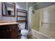 Bathroom featuring a vanity, toilet, shower, tile flooring, mirror, and a rack for bathroom products at 1696 Hunting Creek Dr Se, Conyers, GA 30013