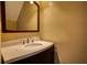 Powder room featuring a stylish vanity with a modern faucet and mirror at 1696 Hunting Creek Dr Se, Conyers, GA 30013
