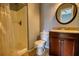 Bathroom featuring a vanity, toilet, shower, tile flooring, mirror, and neutral colored walls at 1696 Hunting Creek Dr Se, Conyers, GA 30013