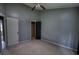 Bedroom featuring carpet flooring, ceiling fan, neutral colored walls, closet and a large window at 1696 Hunting Creek Dr Se, Conyers, GA 30013