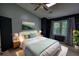 Bedroom with vaulted ceilings, ceiling fan, carpeted floors, artwork on the wall, and windows at 1696 Hunting Creek Dr Se, Conyers, GA 30013