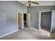 Bedroom featuring carpet flooring, ceiling fan, neutral colored walls, carpet and access to a closet at 1696 Hunting Creek Dr Se, Conyers, GA 30013