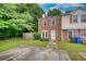 Charming townhome with a brick facade, green lawn, and a private driveway with mature trees at 1696 Hunting Creek Dr Se, Conyers, GA 30013