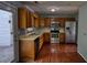 Spacious kitchen with stainless steel appliances, wood cabinets, and hardwood flooring at 1696 Hunting Creek Dr Se, Conyers, GA 30013