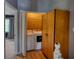 Hallway laundry closet featuring a side-by-side washer and dryer unit and some shelving space for storage at 1696 Hunting Creek Dr Se, Conyers, GA 30013
