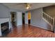 Inviting living room with hardwood floors, fireplace, staircase and entry to the bathroom and kitchen at 1696 Hunting Creek Dr Se, Conyers, GA 30013