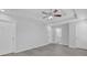 Neutral bedroom with walk-in closet access features tray ceiling, fan, and modern flooring at 4806 Forest Trl, Douglasville, GA 30135
