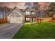 Charming two-story home featuring a gray exterior, two-car garage, well-kept lawn, and welcoming covered front porch at 4806 Forest Trl, Douglasville, GA 30135